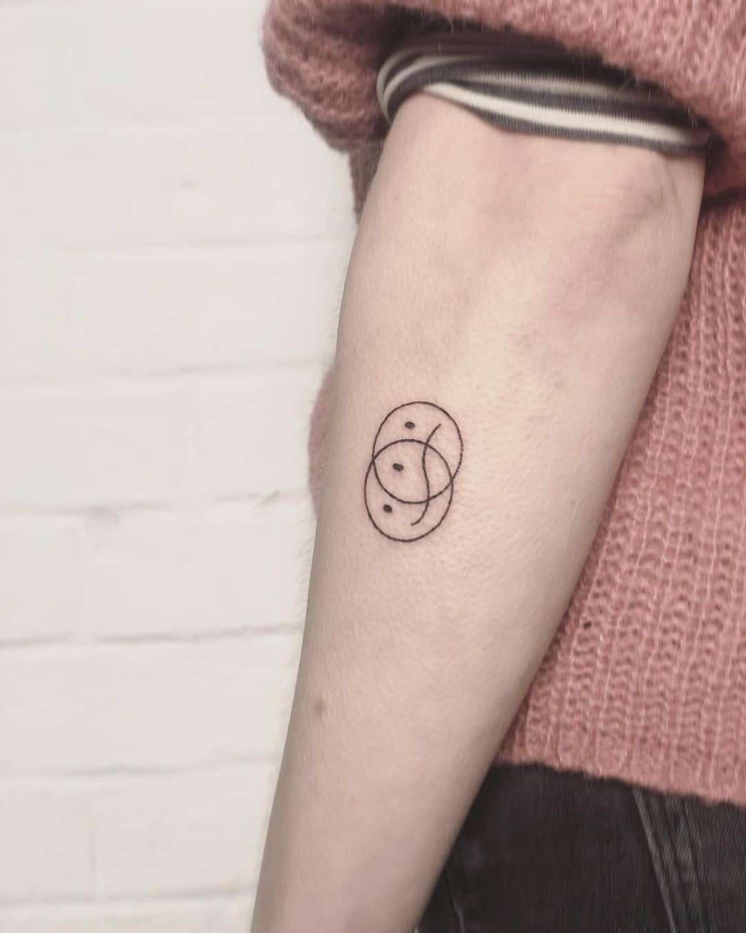 Hand poked minimalist circle tattoo on the left inner